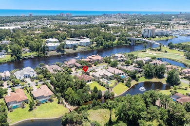 View of urban area featuring a large body of water and a tree filled landscape