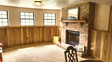 large family room with log burning fireplace