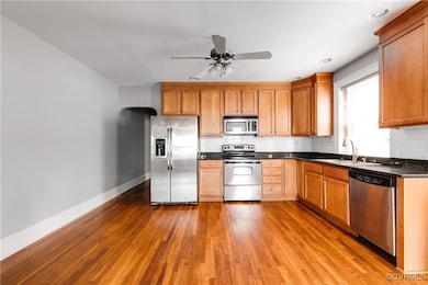 Kitchen with stainless steel appliances, a sink, b