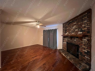 Unfurnished living room with wood finished floors, a fireplace, and ceiling fan