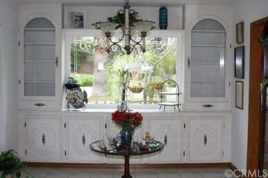 Foyer, built in cabinets, looking out to back yard