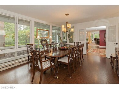 Walls of windows and dark hardwood floors accent t