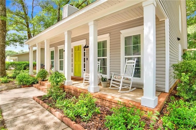 Entrance to property with a porch and a chimney