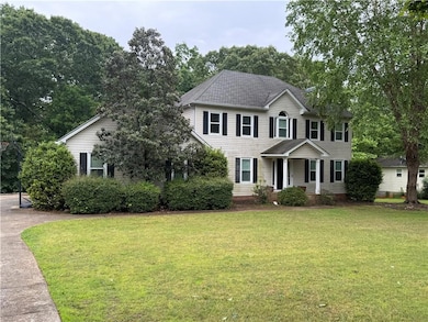 Colonial house featuring roof with shingles and a 