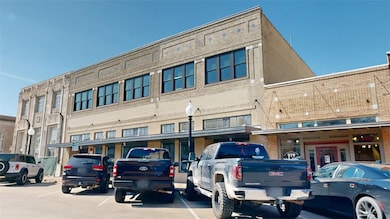 View of property featuring uncovered parking