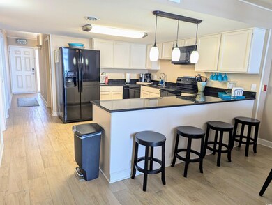 Kitchen featuring a peninsula, light wood-style fl