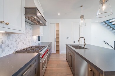 Kitchen featuring dark brown cabinetry, sink, tast