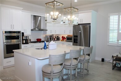 Kitchen with wall chimney range hood, a notable ch