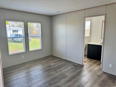 Unfurnished room with a textured ceiling, wood fin