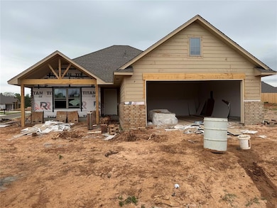 View of front of house featuring a shingled roof, 
