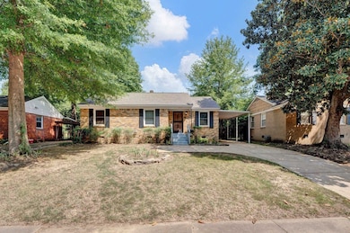 Single story home featuring a front lawn