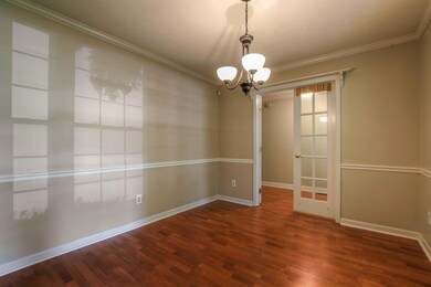 The dining room has a beautiful view of the wooded front yard.