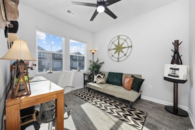 Office space with dark hardwood / wood-style floor