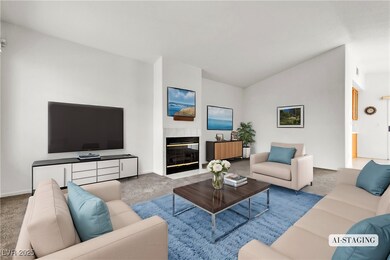 Living room with vaulted ceiling, a fireplace with