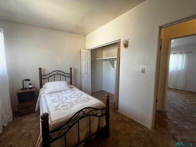 Bedroom featuring dark colored carpet and a closet