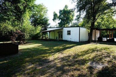 View of green lawn with a patio area