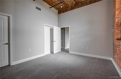 Generous Owner's Suite with exposed brick wall.