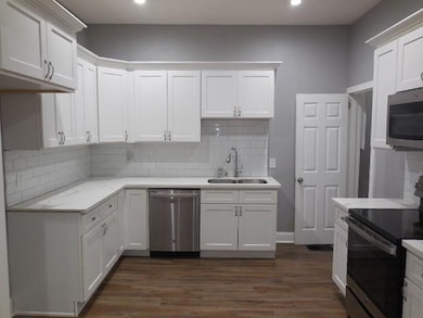 Kitchen featuring stainless steel appliances, a si