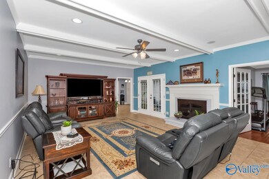 Great room has beautiful tile floors and fireplace.  Centrally located to master, pool and kitchen.