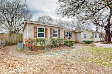 View of front of home with central AC unit, a chim