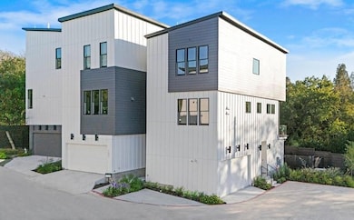 View of front of property featuring board and batten siding and a garage