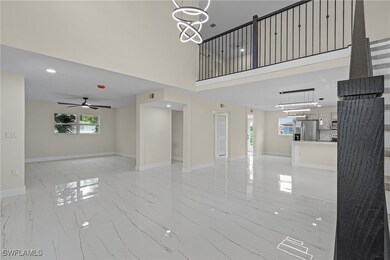 Living room featuring a high ceiling and chandelie