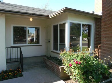 Welcoming front porch with security screen door. N