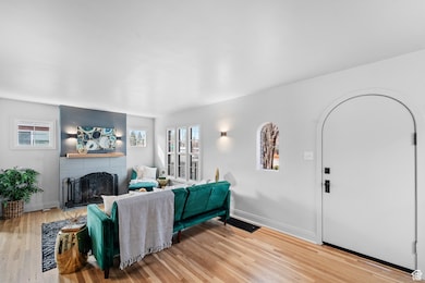 Living area featuring light wood finished floors and a brick fireplace