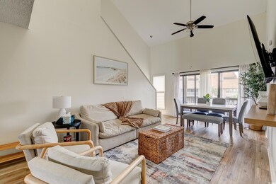 Living room with high vaulted ceiling, ceiling fan