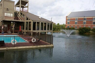 View of the pool, clubhouse, lake and fountain.