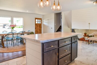 The center island has seating and pendant lighting