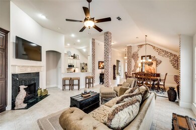 Living room with fireplace open to dining room