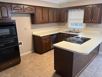 Kitchen featuring black appliances, light tile pat