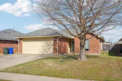 Single story home featuring a front lawn and a gar
