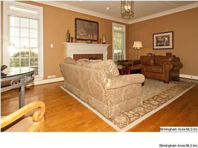 Den with gas log fireplace and plenty of windows.