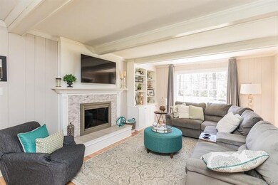 AND a Family Room with Beamed Ceiling and Built In's and Fireplace with Tile Surround!