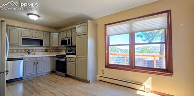 Kitchen with stainless steel appliances, gray cabi