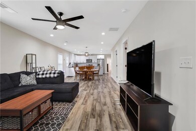 Living area with visible vents, recessed lighting,