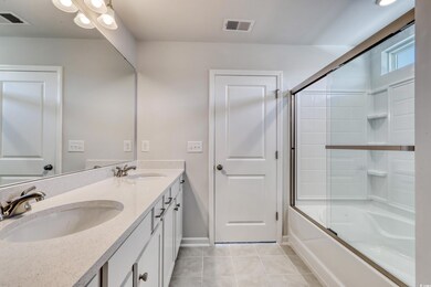 Bathroom featuring vanity, shower / bath combinati