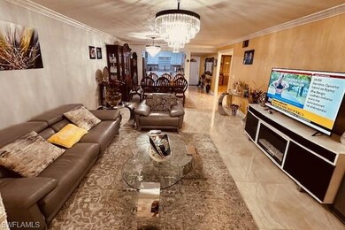 Living room featuring a chandelier and ornamental 