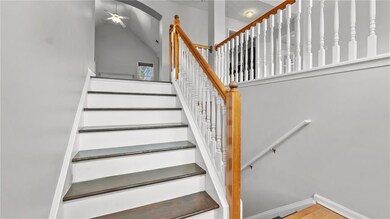 Staircase with ceiling fan, wood finished floors, 
