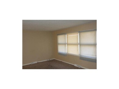 Living room, featuring large windows.