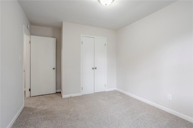 Unfurnished bedroom with carpet and a closet