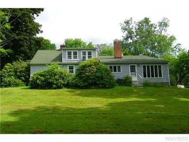 Exterior Back. About 1/2 acre with woods at the ba