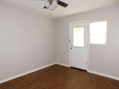 Spare room with dark wood-type flooring, a ceilin