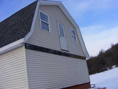 Exterior Back Back of garage showing upstairs door