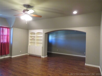 Entry separated with curved walk thru, bookshelves