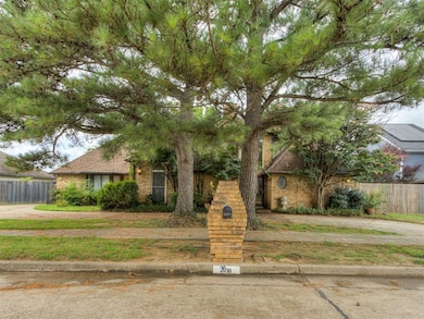 View of front facade featuring brick siding and roof with shingles