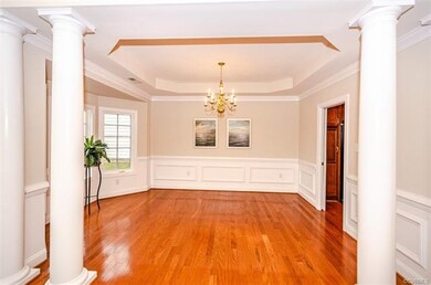 Dining room with tray ceiling, crown chair and pic
