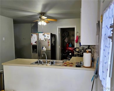 Kitchen featuring light countertops, ceiling fan,
